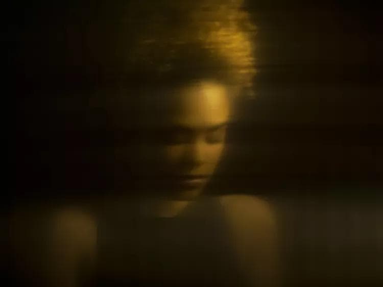 A clean, minimalist workspace with a single laptop showing a code editor and a green 'success' terminal.